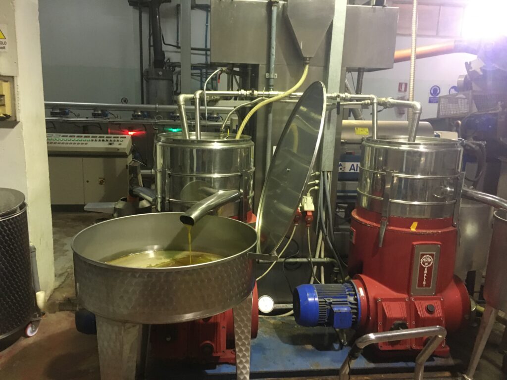 Industrial oil extraction equipment with stainless steel tanks and processing machinery.